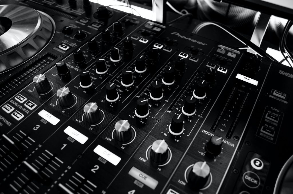 Black and white image of an audio mixing desk